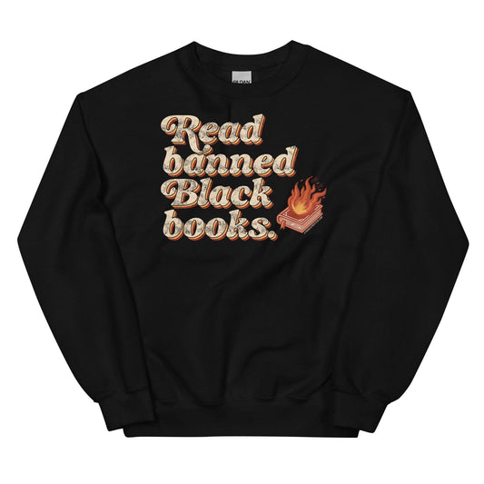 Black unisex sweatshirt with 'Read Banned Black Books' text and a flaming book graphic, promoting cultural awareness and resistance to erasure.