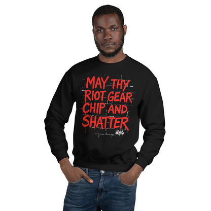 Man modeling May Thy Riot Gear Chip And Shatter Unisex Sweatshirt in black, featuring striking red protest lettering.