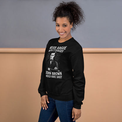 Woman wearing black 'Never Argue With Somebody John Brown Would Have Shot' unisex sweatshirt, showcasing statement apparel in casual setting.
