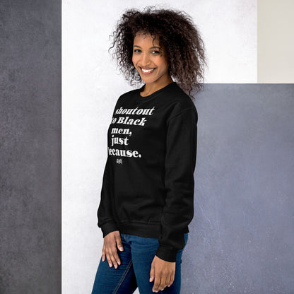 Woman in black sweatshirt with bold white 'Shoutout To Black Men Just Because' message