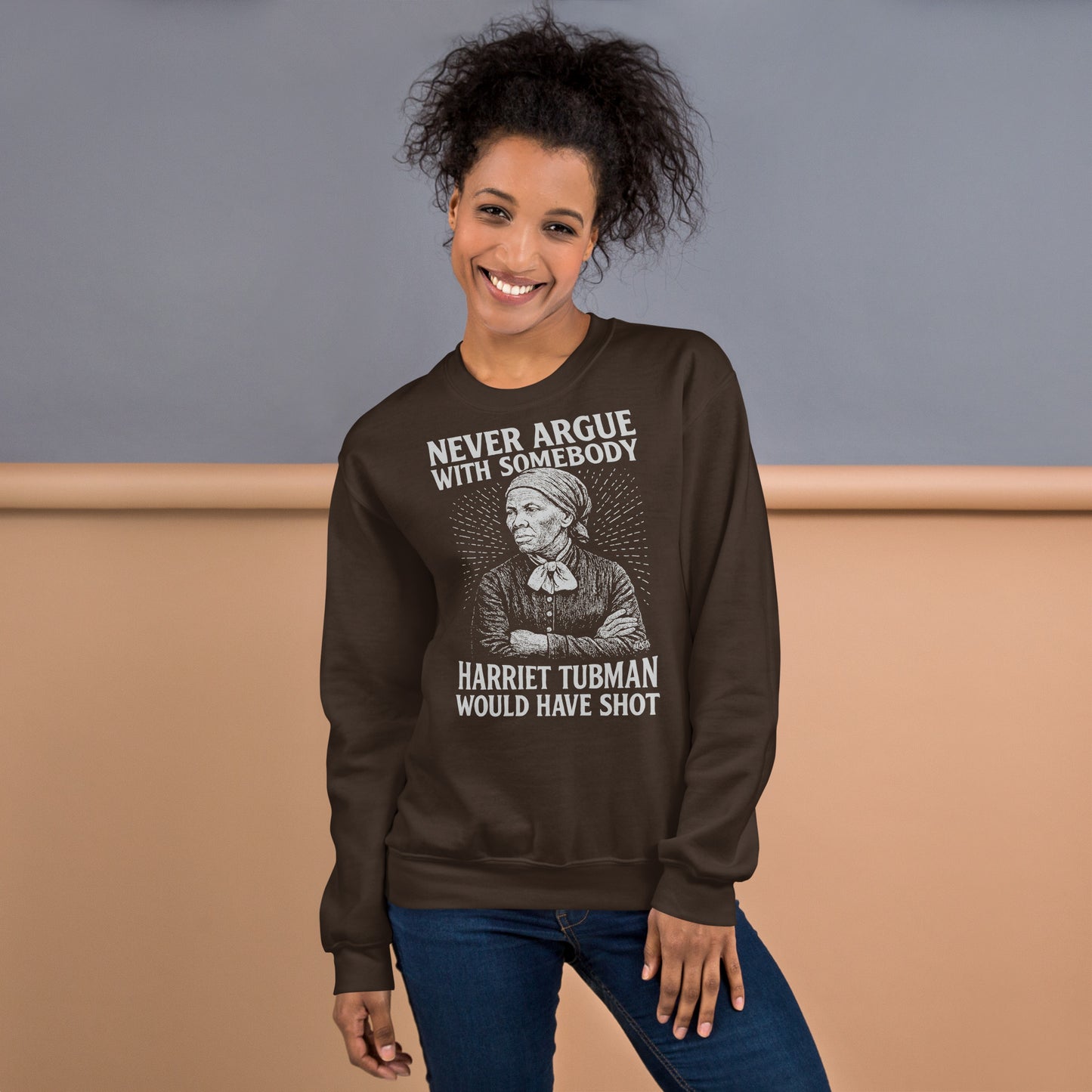 Model wearing brown Never Argue Harriet Tubman Would Have Shot Unisex Sweatshirt, showcasing relaxed fit and bold historical statement.