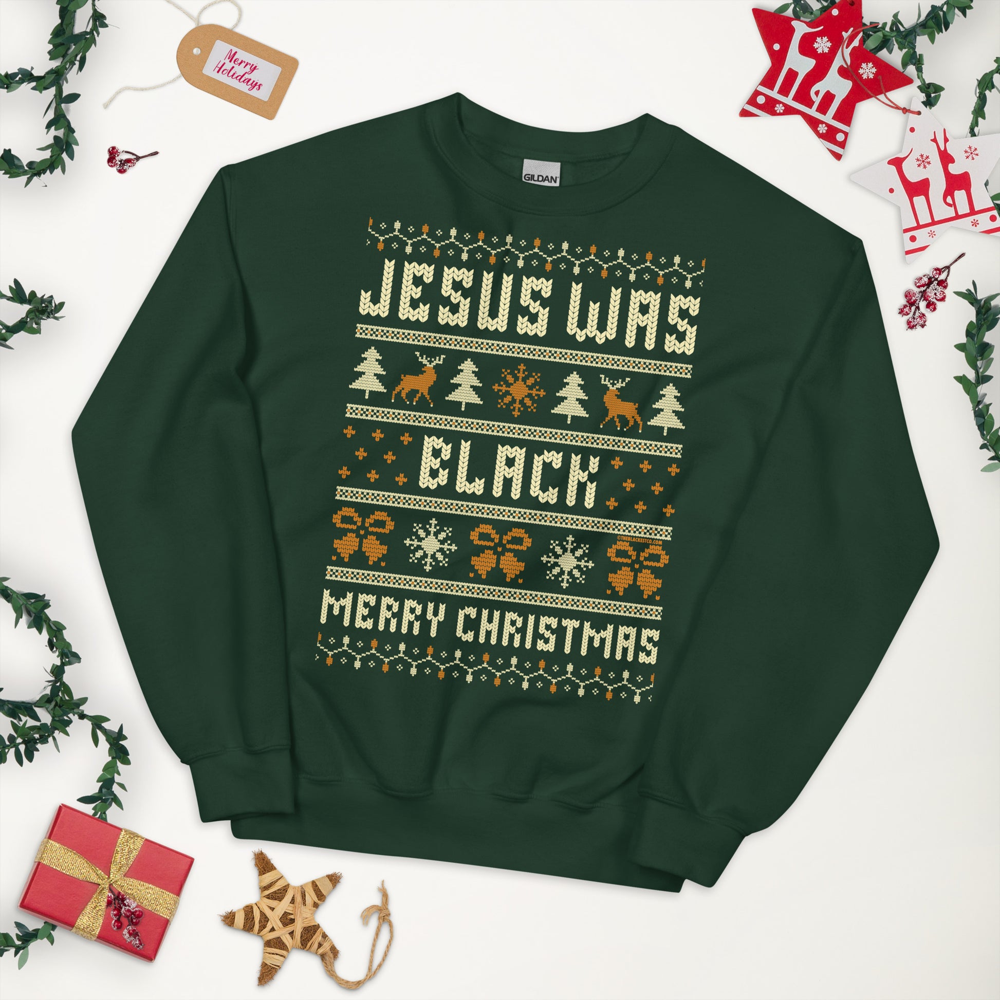 Green Jesus Was Black Merry Christmas Unisex Sweatshirt by TheBlackest Co. styled flat lay with festive holiday decor, ideal for gifting.
