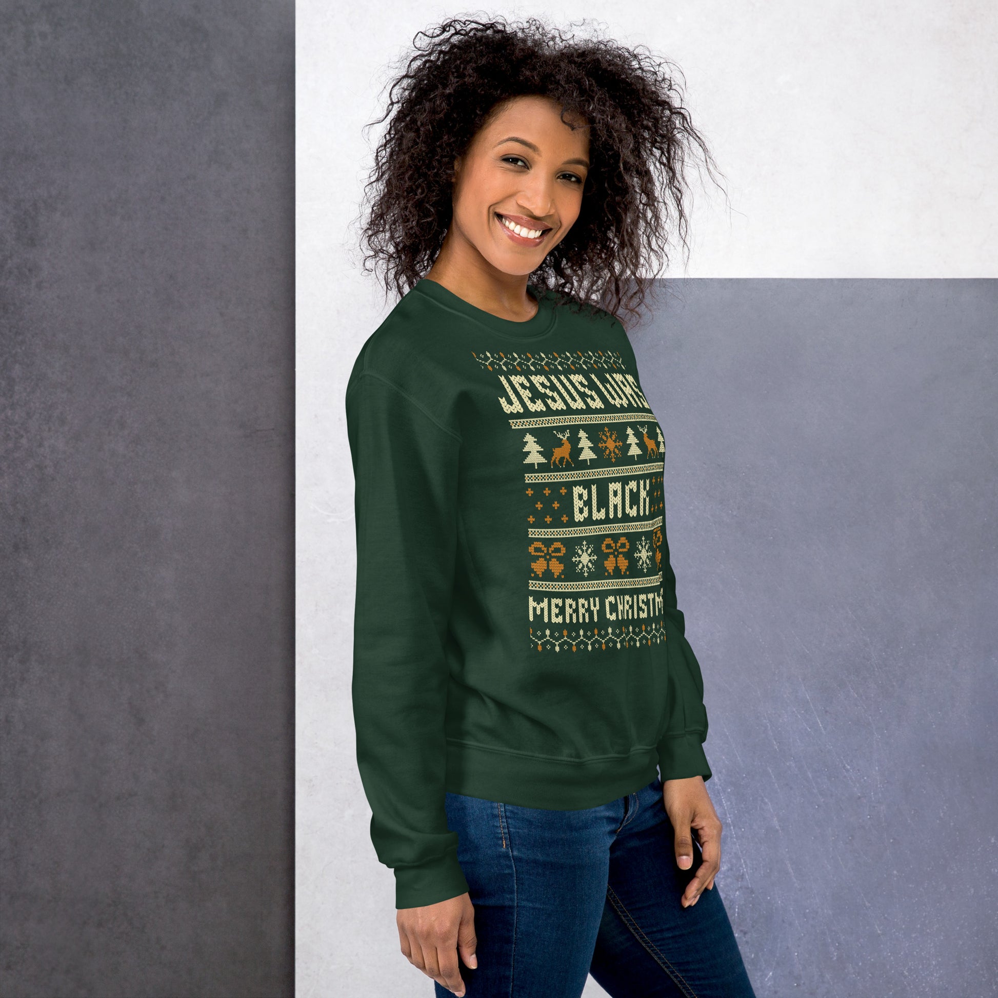 Smiling woman in green Jesus Was Black Merry Christmas Unisex Sweatshirt by TheBlackest Co., festive and empowering winter wear.