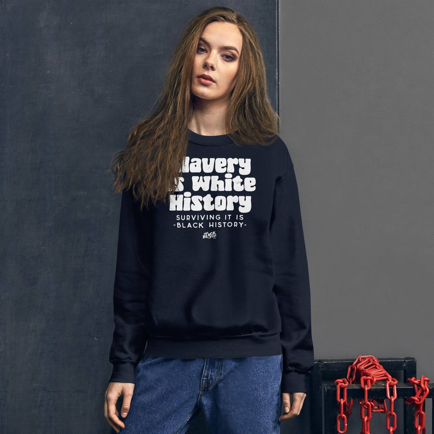 Model wearing ALLY VERSION Slavery Is White History Sweatshirt by TheBlackest Co., styled with casual jeans, highlighting bold ally support.