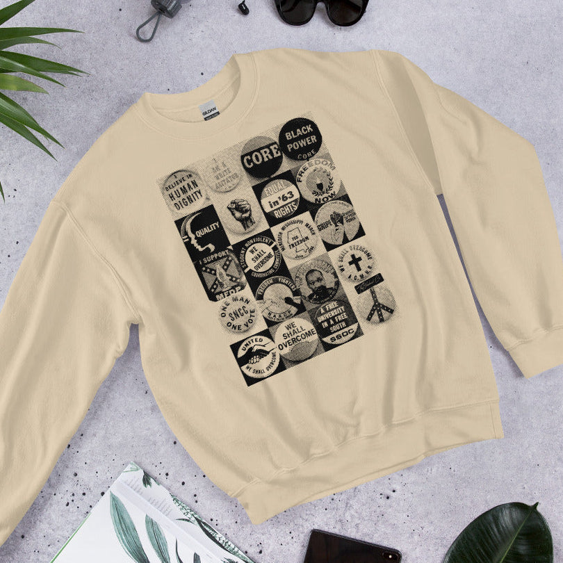 Flat lay of beige Civil Rights Button Sweatshirt with retro civil rights graphics. Ideal cozy gear for history lovers and cold weather fashion.
