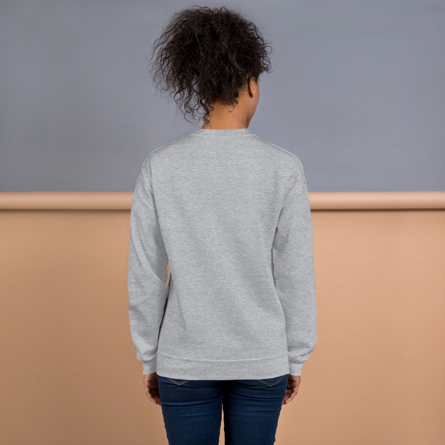 Back view of woman wearing gray sweatshirt