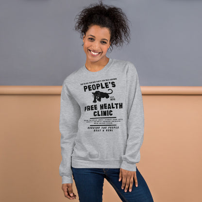 Woman smiling in gray People's Free Health Clinic sweatshirt