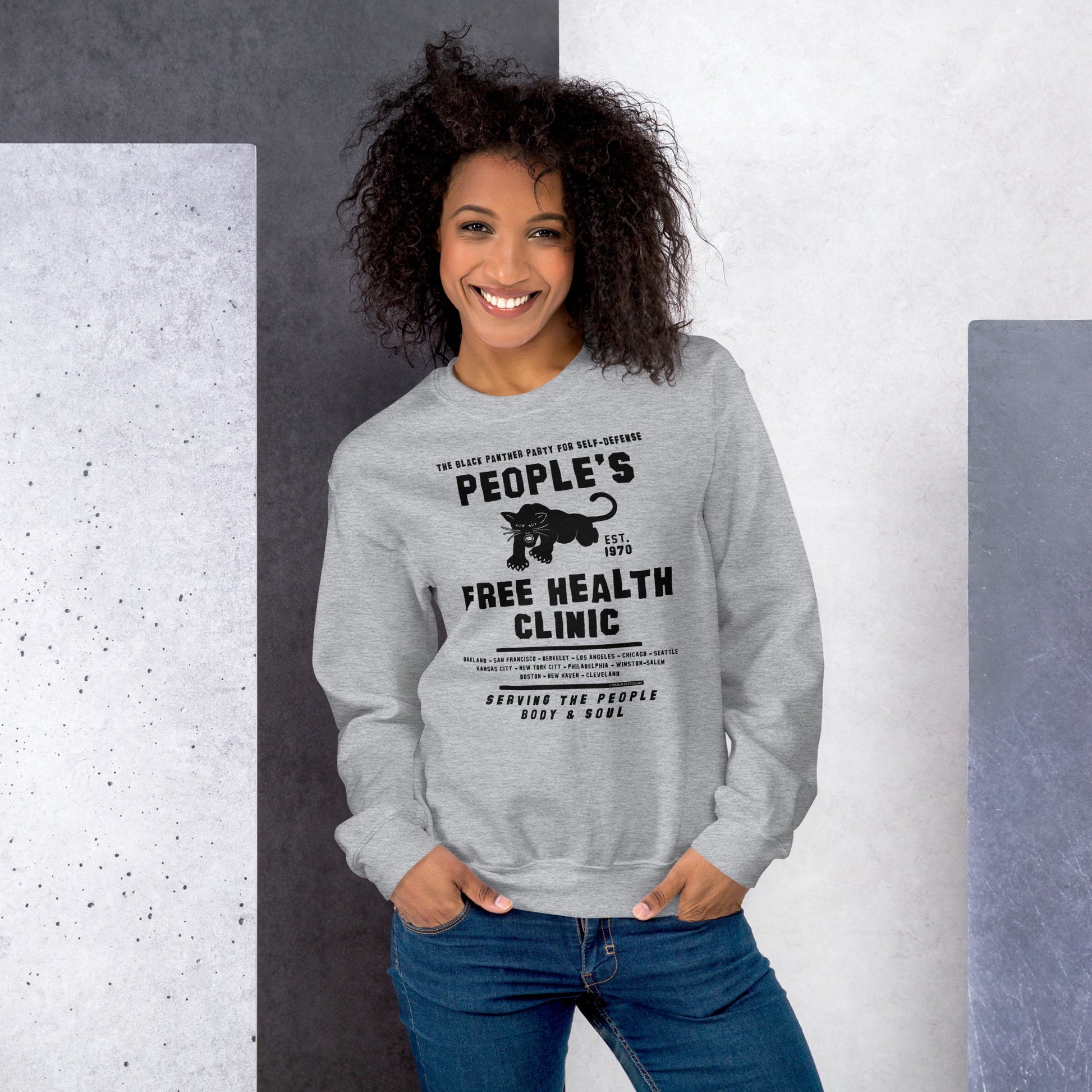 Woman posing in gray People's Free Health Clinic sweatshirt