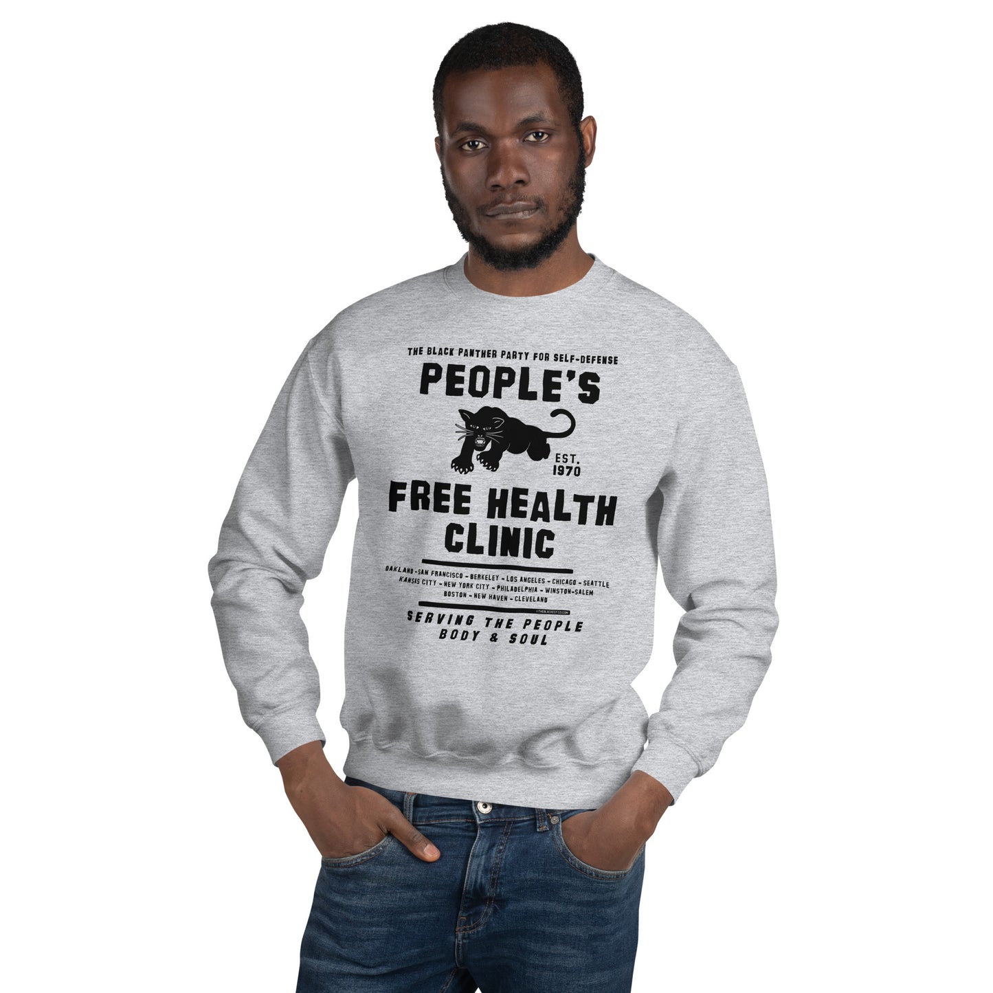 Man in gray People's Free Health Clinic sweatshirt, hands in pockets