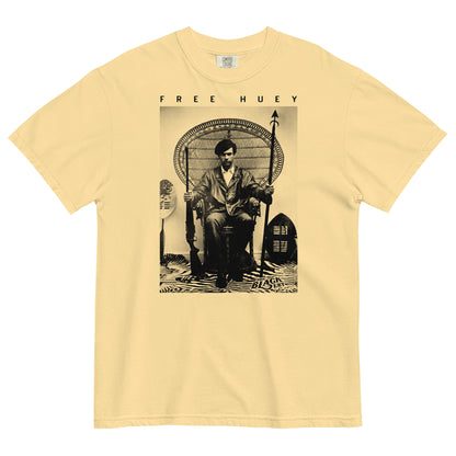 a butter yellow t shirt with a picture of huey p newton sitting on a wicker chair