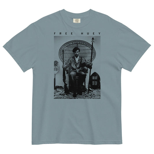 a blue t shirt with a picture of huey p newton sitting on a wicker chair