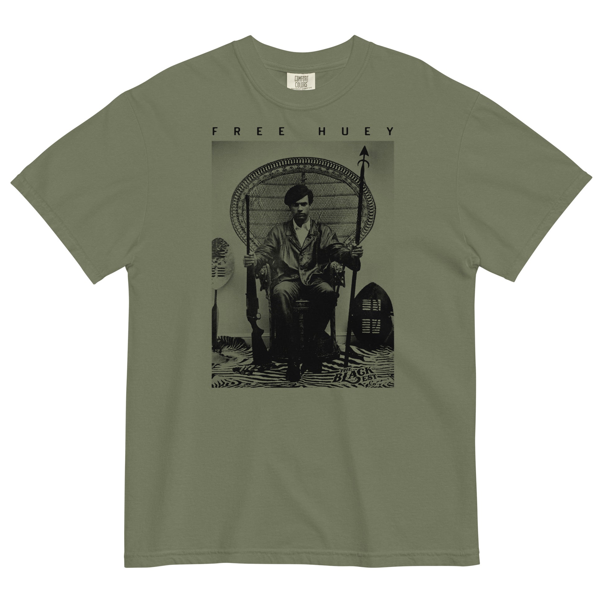 a olive green t shirt with a picture of huey p newton sitting on a wicker chair