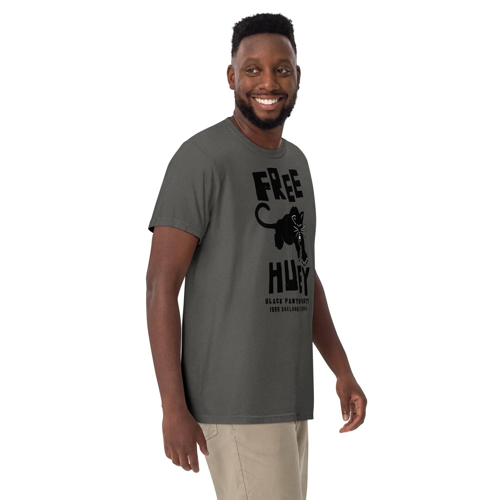 a man wearing a gray t - shirt with a black panther on it and says free huey