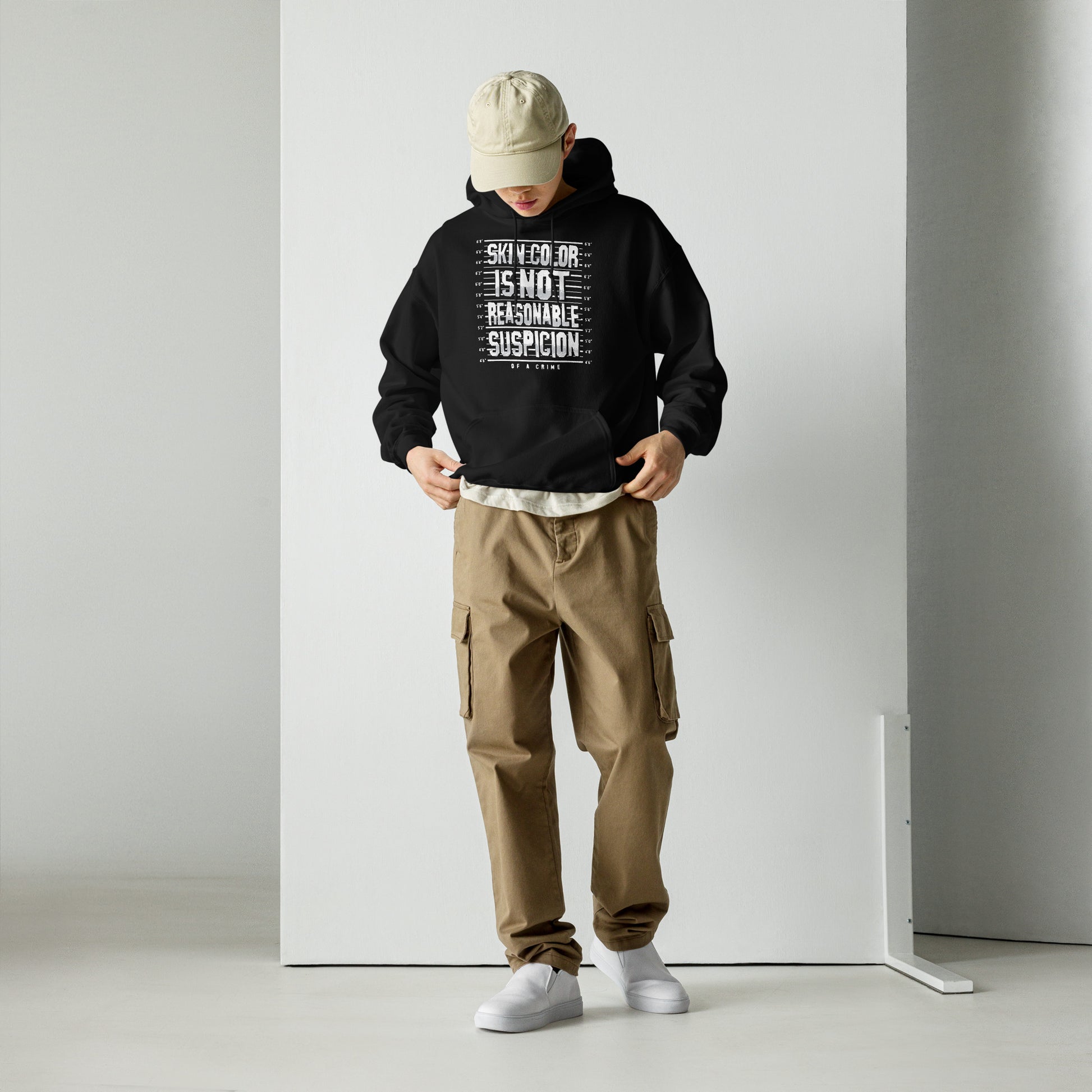 Streetwear look with Skin Color Is Not A Crime Unisex Hoodie by TheBlackest Co., styled with cargo pants for a bold activist fashion statement.