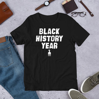 Black History Year Afro Pick T-Shirt on flatlay with jeans.