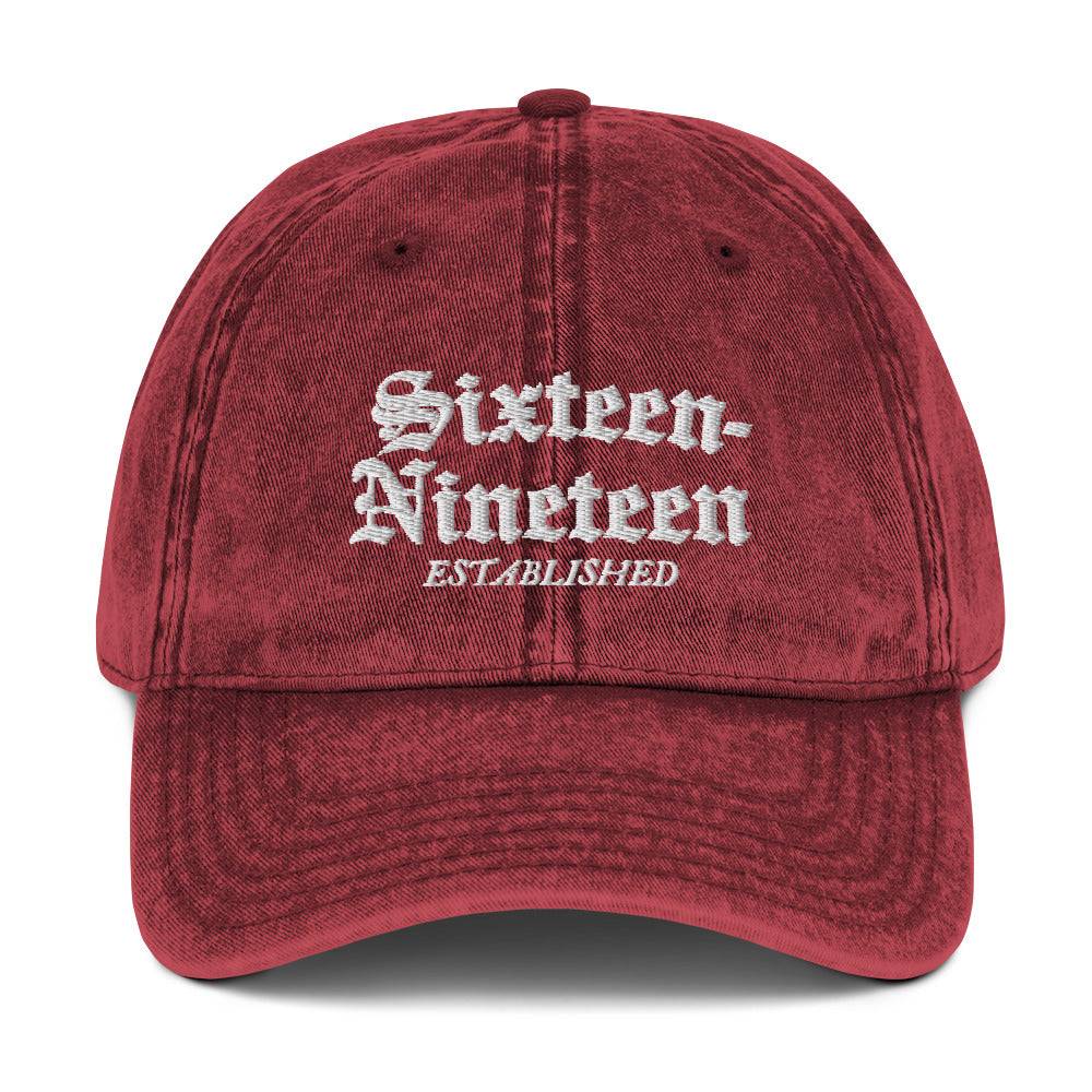 a red hat that says sixteen nineteen established