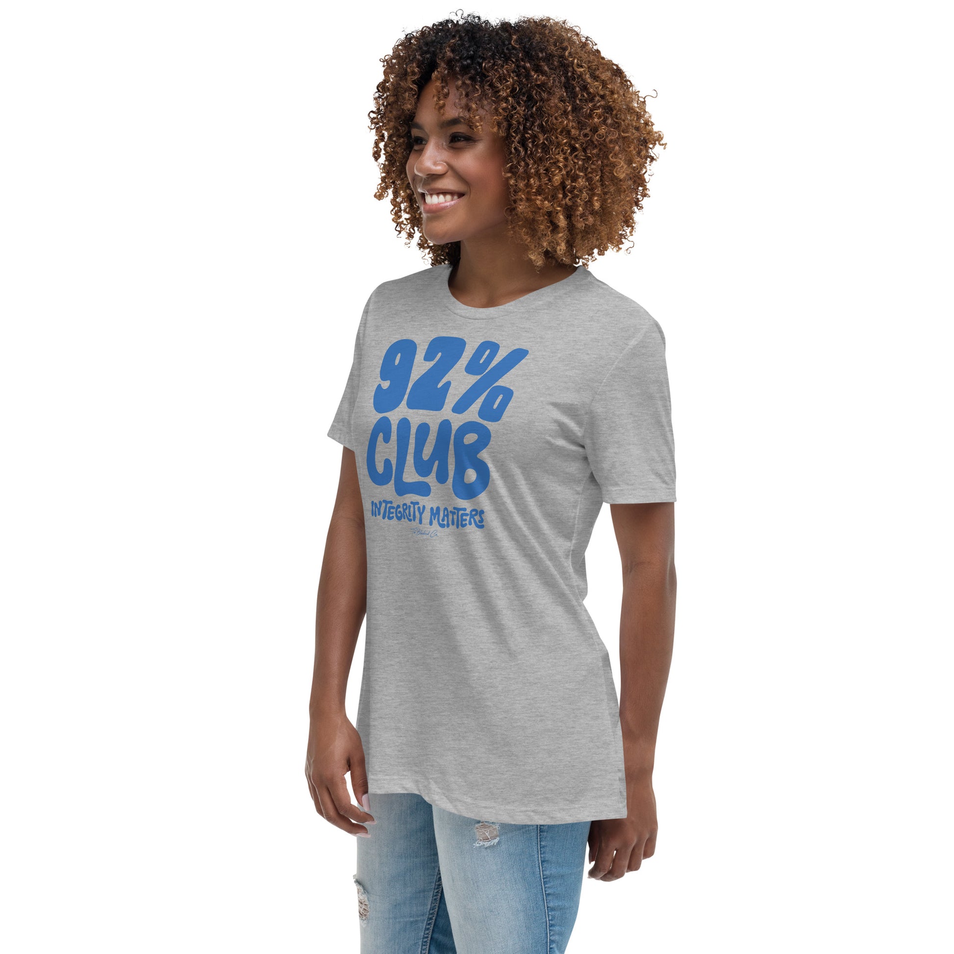 Model wearing a heather gray 92% Club Women's Relaxed T-Shirt by TheBlackest Co., featuring bold blue text '92% Club Integrity Matters.'