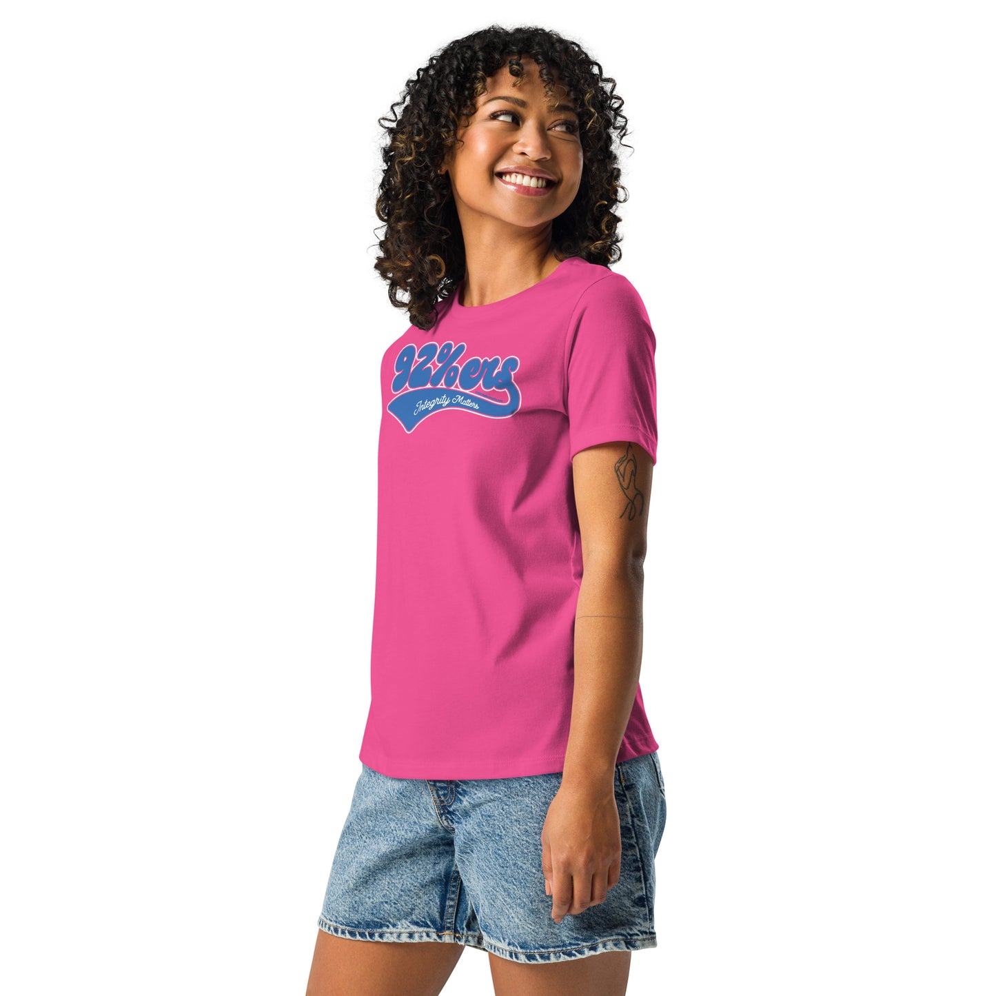 Woman in a bright pink '92 Percenter Integrity Matters' relaxed t-shirt paired with denim shorts, vibrant and casual.