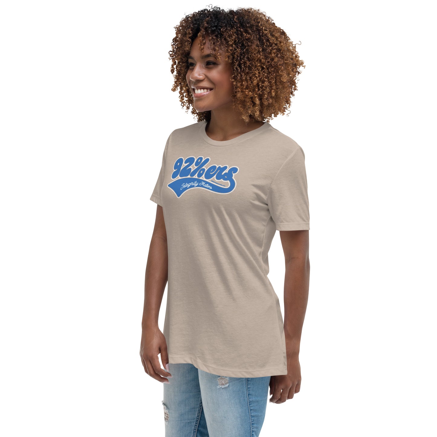 Woman in a beige '92 Percenter Integrity Matters' relaxed t-shirt styled with light blue jeans, neutral and chic.