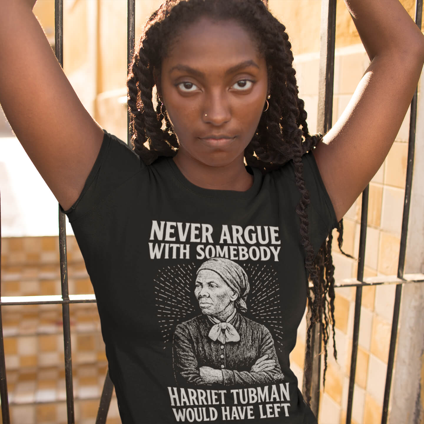 Black woman wearing Never Argue Harriet Tubman Would Have Left Unisex Staple T-Shirt in black, featuring bold historical graphic design.