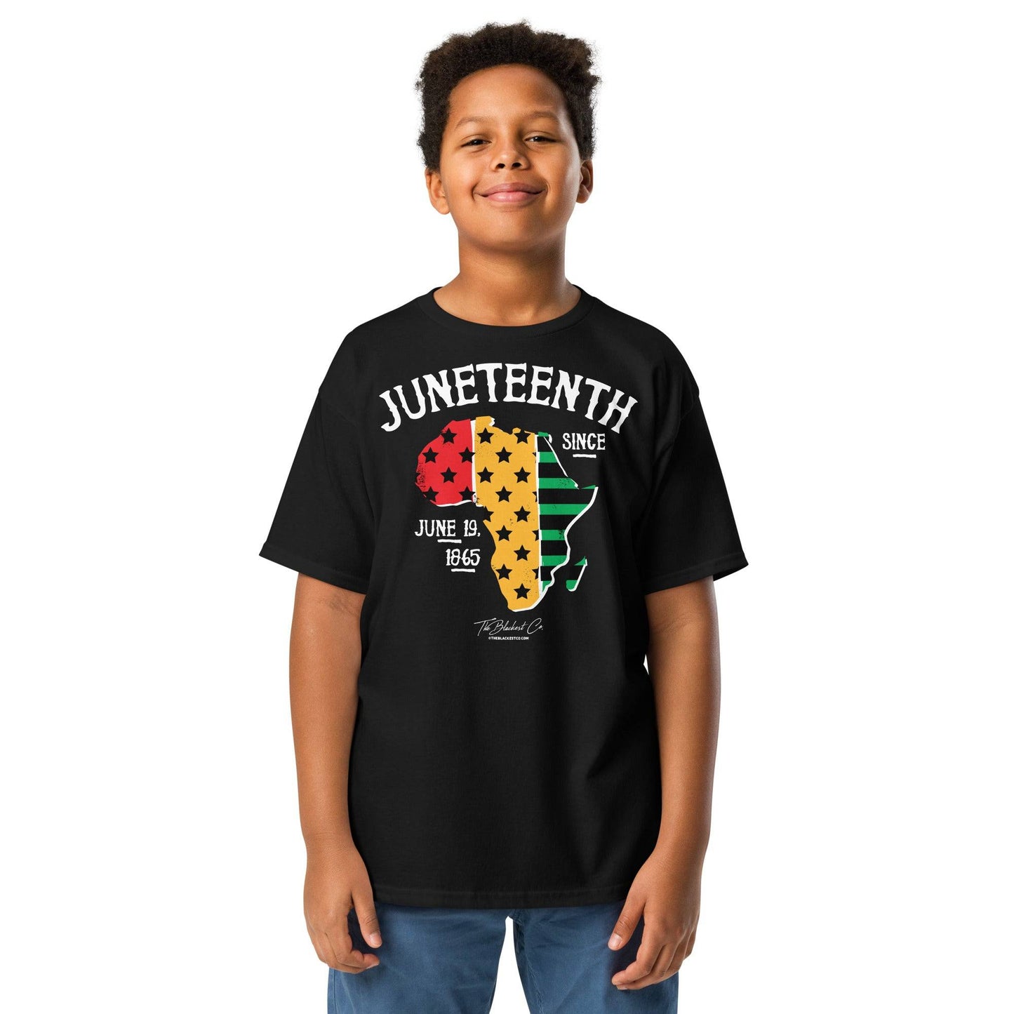 a young boy wearing juneteenth t-shirt standing in front of a white background