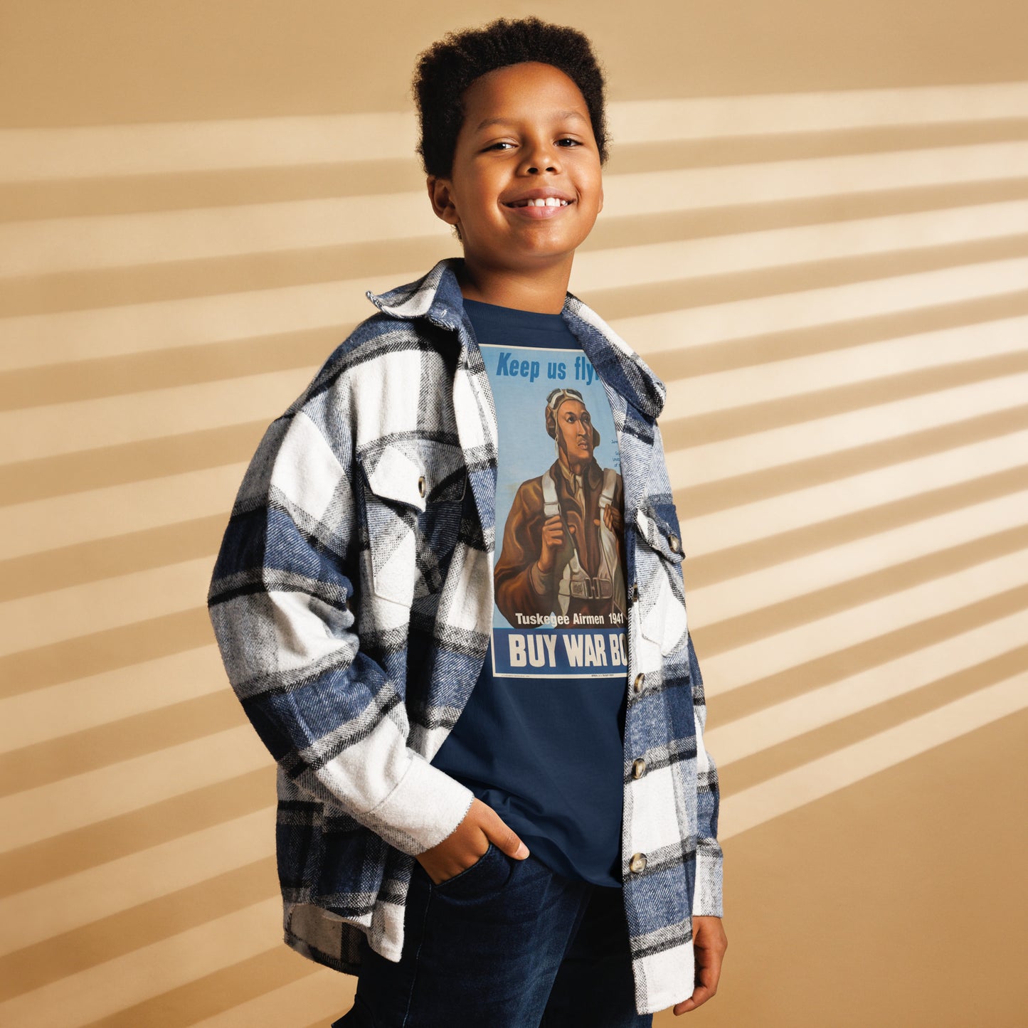 Child wearing Tuskegee Airmen t-shirt under flannel shirt