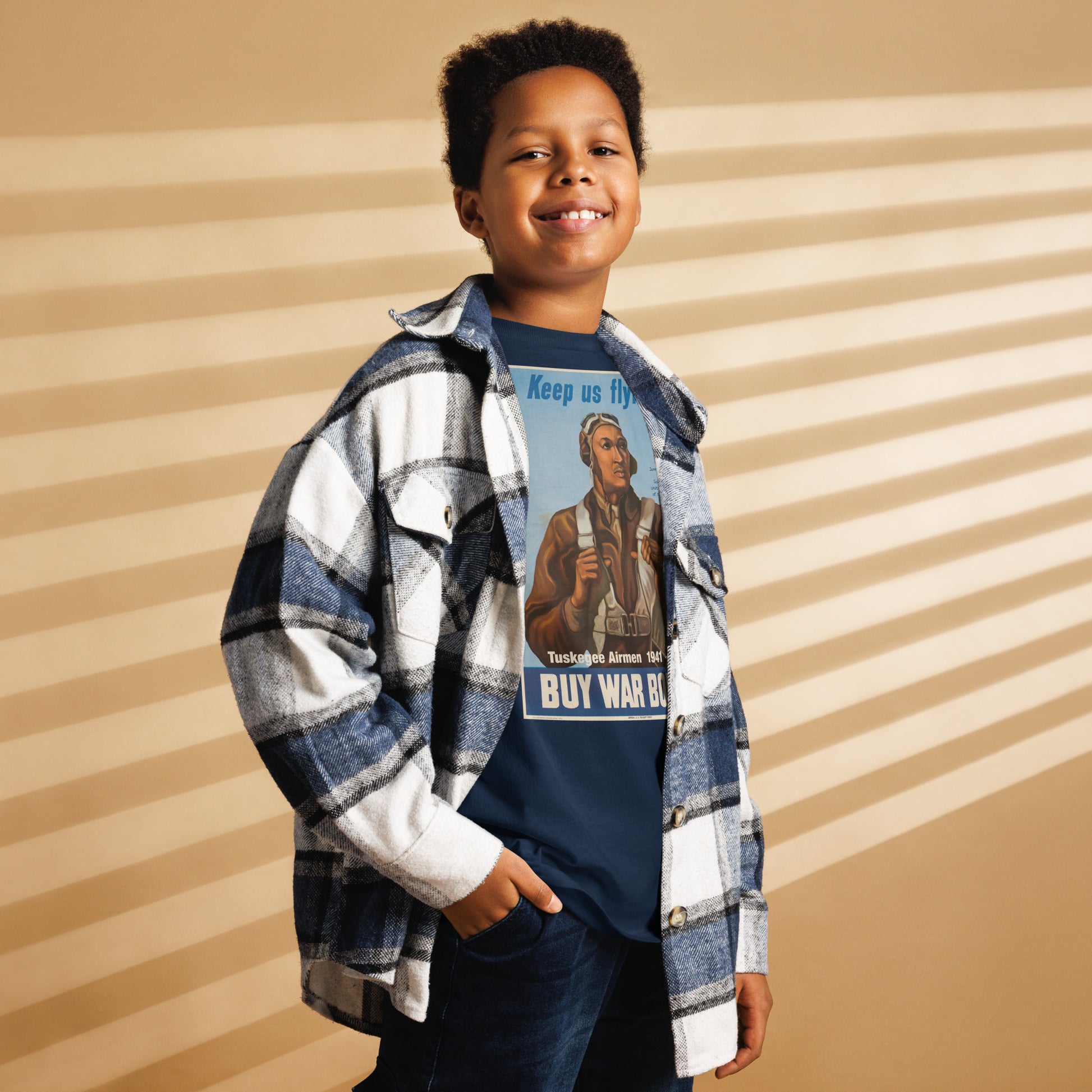 Child wearing Tuskegee Airmen t-shirt under flannel shirt