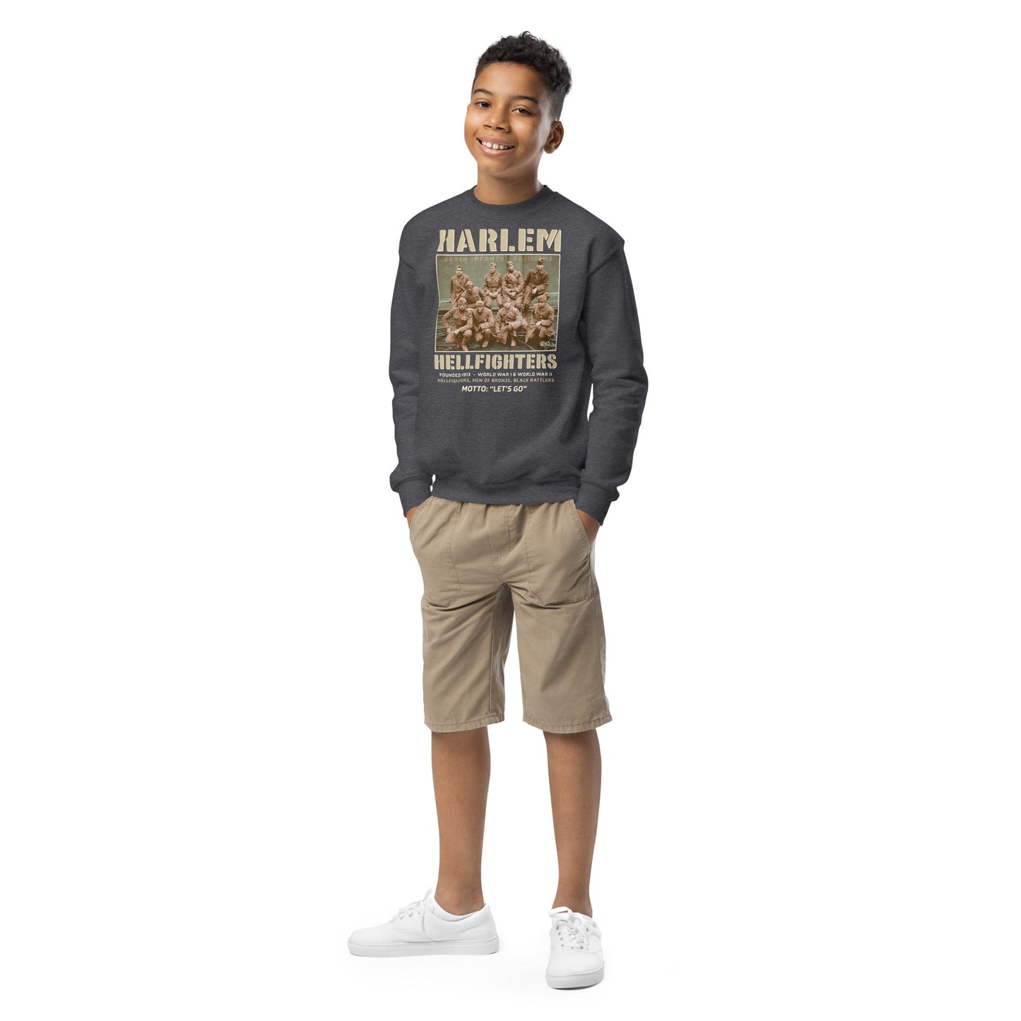 Full-body view of a boy wearing Harlem Hellfighters youth sweatshirt in dark gray. Stylish pullover with historical design, perfect for casual wear.