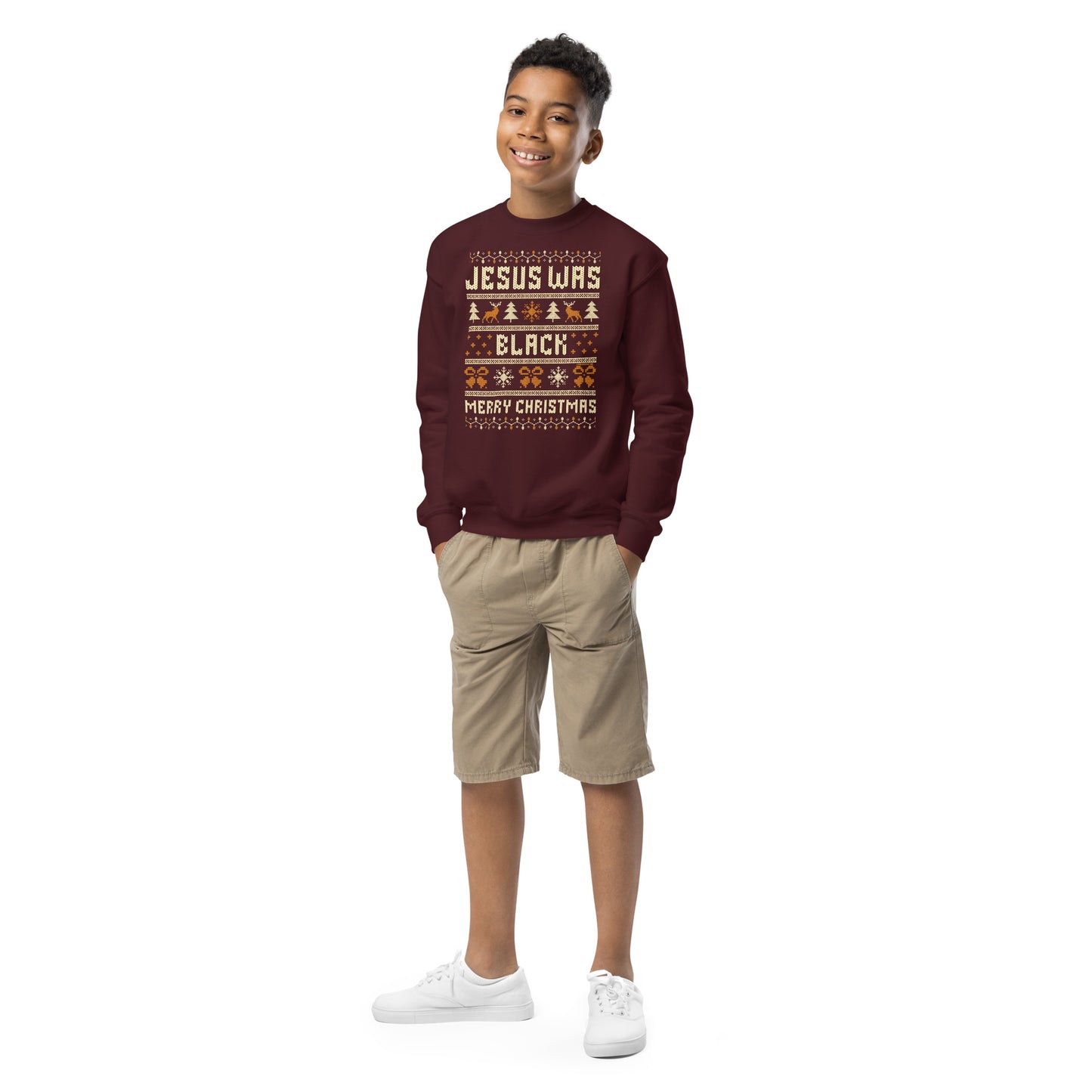 Smiling boy wearing Youth Jesus Was Black Merry Christmas crewneck sweatshirt in maroon, styled for cozy and festive kids holiday wear.