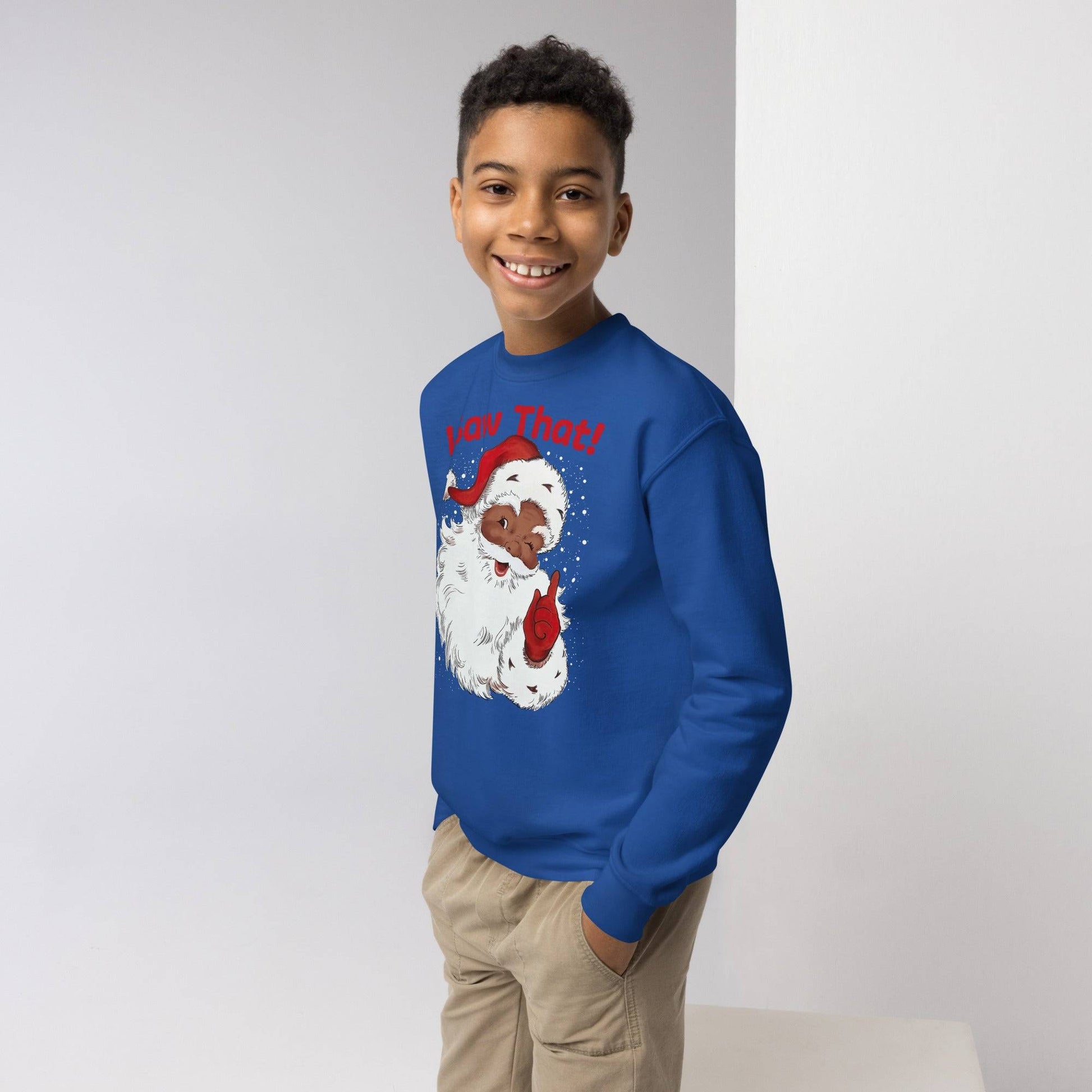 Youth smiling in royal blue Black Santa I Saw That Crewneck Sweatshirt by TheBlackest Co., cozy and fun holiday kids clothing.