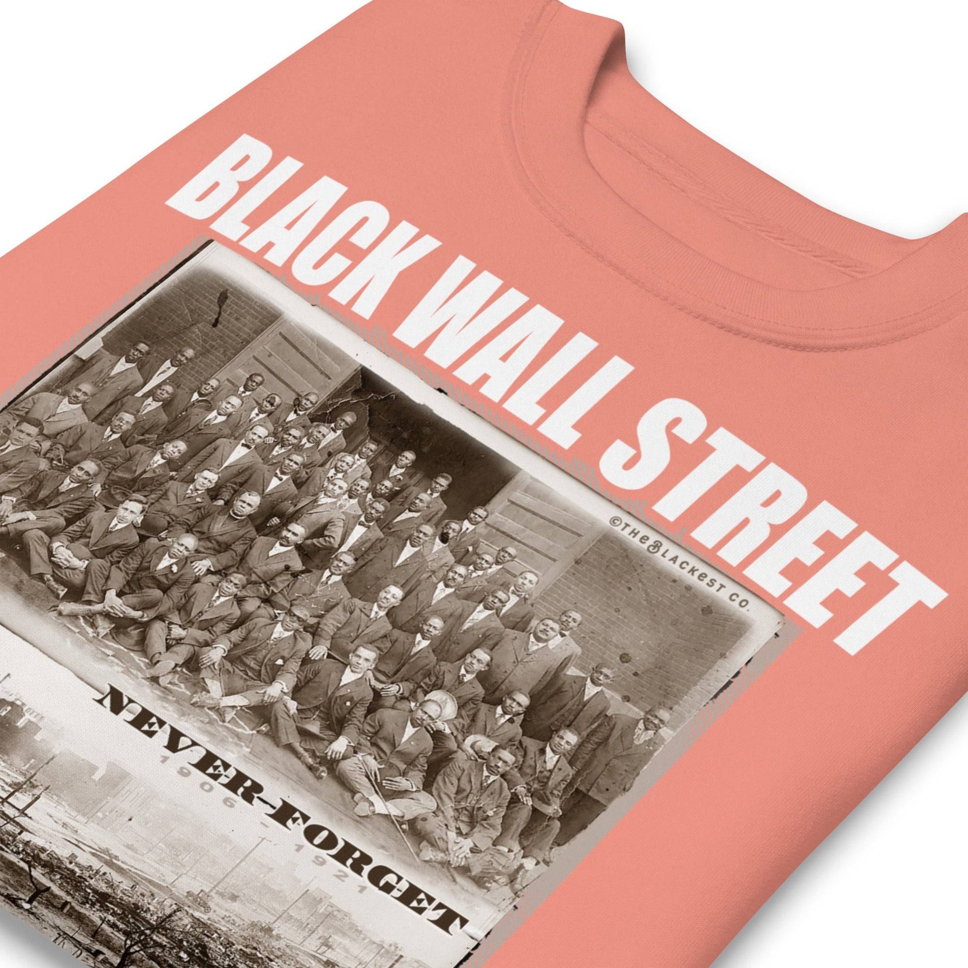 folded coral pink premium sweatshirt with writing that says Black Wall Street and Greenwood